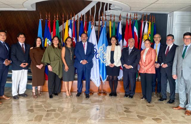 Entities' managers pose in front of their country's flags during the signed cooperation framework event.